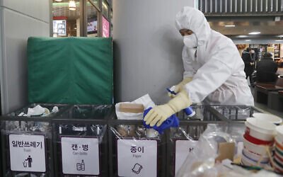 An employee works to prevent the spread of a new coronavirus at Suseo Station in Seoul, South Korea, January 24, 2020. (Ahn Young-joon/AP)