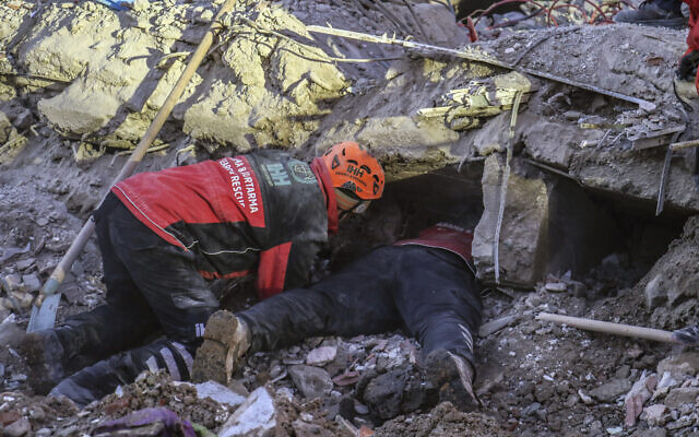 Rescue workers try to save people trapped under debris following a strong earthquake that destroyed several buildings on Friday, in Elazig, eastern Turkey on January 26, 2020. (Ismail Coskun/IHA via AP) Rescue workers try to save people trapped under debris following a strong earthquake that destroyed several buildings on Friday, in Elazig, eastern Turkey on January 26, 2020. (Ismail Coskun/IHA via AP)