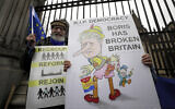 Anti-Brexit campaigners hold banners outside Parliament in London on January 30, 2020. (AP Photo/Kirsty Wigglesworth)