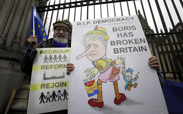 Anti-Brexit campaigners hold banners outside Parliament in London on January 30, 2020. (AP Photo/Kirsty Wigglesworth) Anti-Brexit campaigners hold banners outside Parliament in London on January 30, 2020. (AP Photo/Kirsty Wigglesworth)
