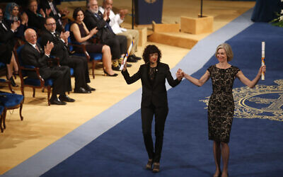 FILE -- Emmanuelle Charpentier of France, left and Jennifer Doudna of the US are applauded by other prize winners after receiving the Princess of Asturias Technical and Scientific Research award from Spain's King Felipe VI at a ceremony in Oviedo, northern Spain, Oct. 23, 2015.  (AP Photo/Jose Vicente)
