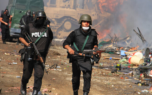 Egyptian security forces clear a sit-in camp set up by supporters of ousted Islamist president Mohammed Morsi in Nasr City district, Cairo, August 14, 2013. (Ahmed Gomaa/AP)