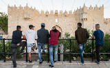 Illustrative: Palestinians standing outside Damascus Gate in the Old City, East Jerusalem on May 14, 2018. (Dario Sanchez/Flash90)