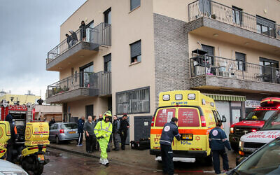 Rescue teams and security forces at the scene where a man and a woman drowned after they were trapped in an elevator that became engulfed by floodwaters in Tel Aviv on January 4, 2020. (Flash90)