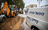 Nahariya municipality workers work in the streets of the northern Israeli city which was suffered severe flooding due to heavy rain storms, January 9, 2020. (David Cohen/Flash90)