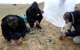 Young Palestinian men prepare flammable objects to be launched toward Israel, near Rafah in the southern Gaza Strip, January 18, 2020. (Abed Rahim Khatib/Flash90)