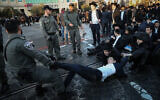 Ultra-Orthodox Jewish men clash with Israeli police as they protest against the jailing of a yeshiva student who failed to comply with an army recruitment order, in Jerusalem on January 26, 2020. (Yonatan Sindel/Flash90)