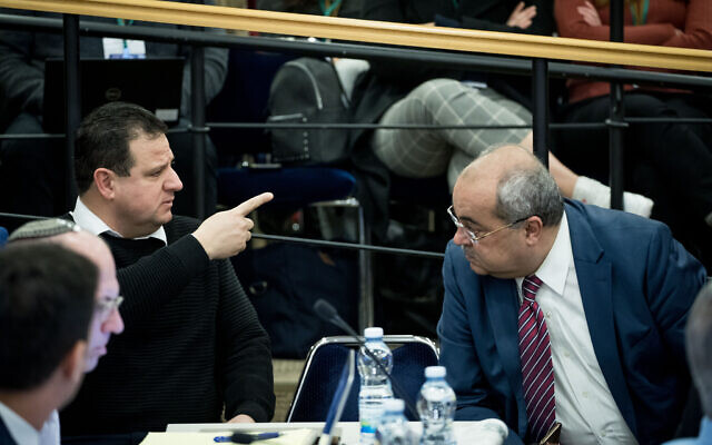 Leader of the Joint List Ayman Odeh (L) with fellow faction member Ahmad Tibi during the Central Elections Committee discussion of requests to disqualify Joint List party candidate Heba Yazbak from running in the upcoming Knesset Elections on January 29, 2020. (Yonatan Sindel/Flash90) Leader of the Joint List Ayman Odeh (L) with fellow faction member Ahmad Tibi during the Central Elections Committee discussion of requests to disqualify Joint List party candidate Heba Yazbak from running in the upcoming Knesset Elections on January 29, 2020. (Yonatan Sindel/Flash90)