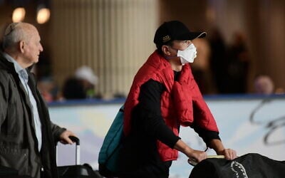 A man wearing a face mask at the arrivals hall of Ben Gurion Airport on January 30, 2020. (Tomer Neuberg/Flash90)