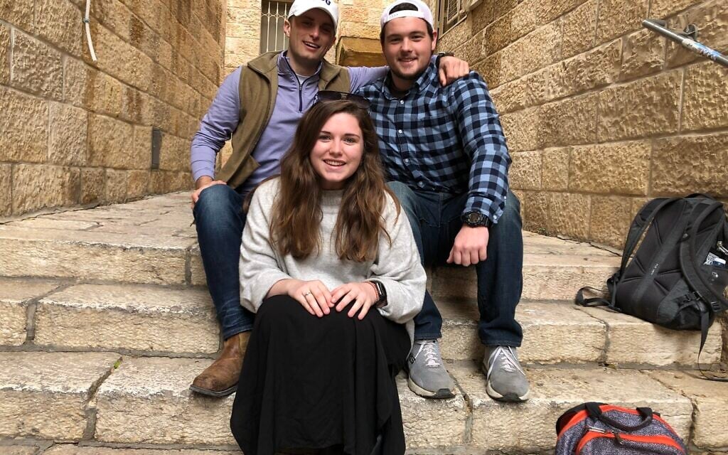 Left to right: Cage Sawyers, Kate Mullen, and Seth Bray take a break in Jerusalem's Old City on a Passages trip, January 5, 2020. (Renee Ghert-Zand/TOI)