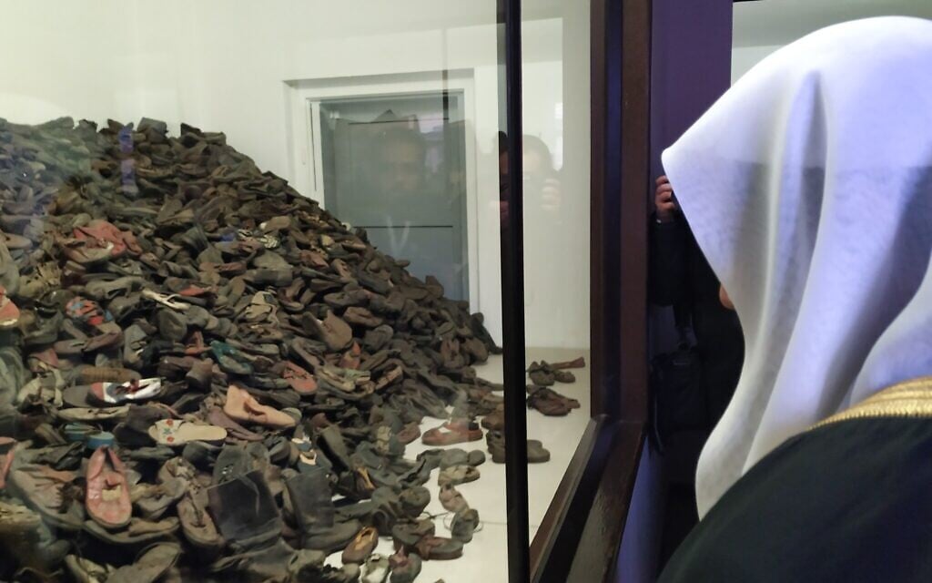 Muslim World League head Mohammed al-Issa looks at piles of shoes once owned by Jews at Auschwitz, January 23, 2020. (Yaakov Schwartz/Times of Israel)