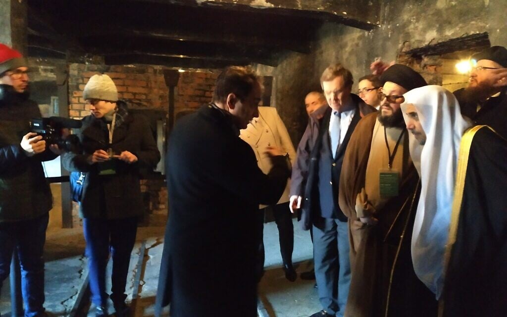 Muslim World League head Mohammed al-Issa, right, looks at the equipment used to incinerate Jews at Auschwitz, January 23, 2020. (Yaakov Schwartz/ Times of Israel)