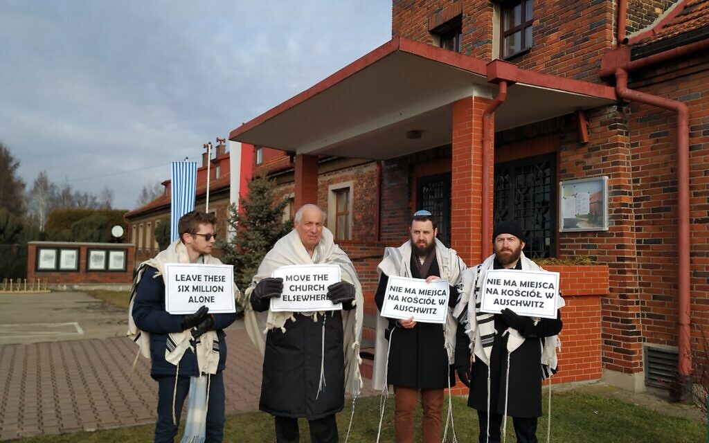 From left to right, rabbis Shabbos Kestenbaum, Avi Weiss, Ezra Seligsohn, and Jonathan Leener protest the location of a church in a former SS headquarters across from the former Nazi death camp Birkenau, January 27, 2020. (Yaakov Schwartz/ Times of Israel)