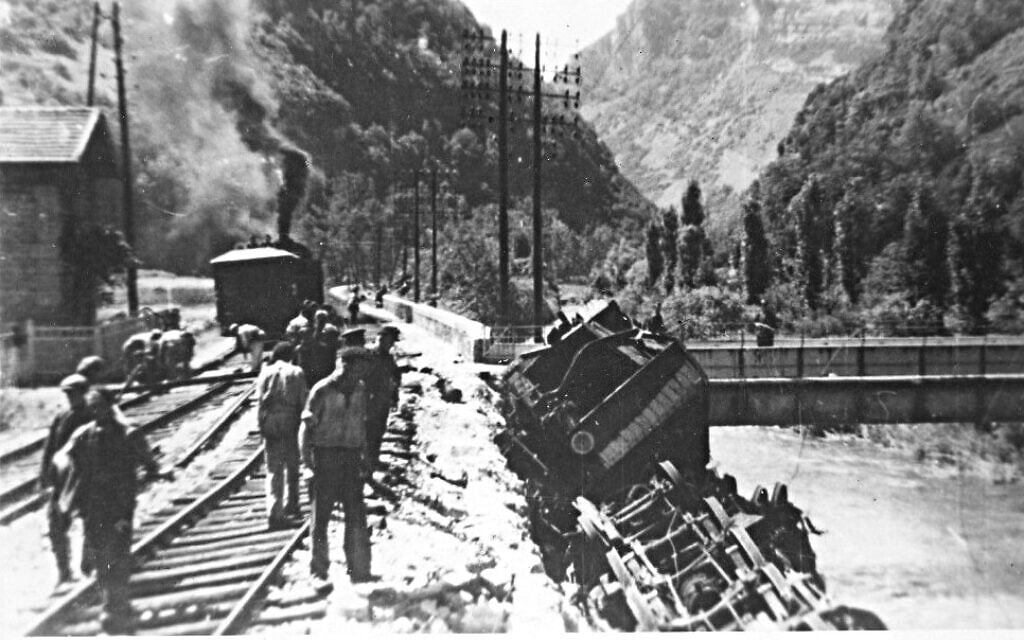 A derailed train lying on its side, the result of sabotage by Resistance fighters in France, June 9, 1944. The photo was taken by a German officer who would be killed by another Resistance ambush minutes later, and the film recovered and developed by the operatives. (Public domain)