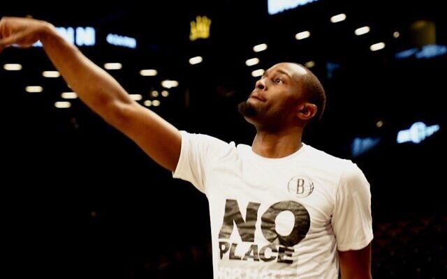 Theo Pinson of the Brooklyn Nets warms up at the Barclays Center in Brooklyn on Jan. 12, 2020, wearing a 'No Place for Hate\ shirt. (Courtesy of the Anti-Defamation League via JTA) Theo Pinson of the Brooklyn Nets warms up at the Barclays Center in Brooklyn on Jan. 12, 2020, wearing a 'No Place for Hate\ shirt. (Courtesy of the Anti-Defamation League via JTA)