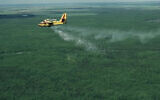 A plane releases fire-extinguishing pellets using Elbit's HyDrop high-altitude firefighting technology. (YouTube screenshot)
