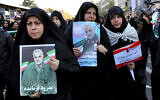 Mourners holding posters of Iranian general Qassem Soleimani attend a funeral ceremony in Tehran, Iran, January 6, 2020. (AP Photo/Ebrahim Noroozi)