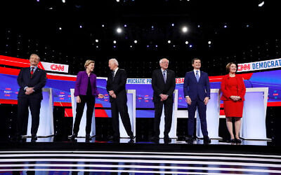From left, Democratic presidential candidates Tom Steyer, Sen. Elizabeth Warren, D-Mass., former Vice President Joe Biden, Sen. Bernie Sanders, I-Vt., former South Bend Mayor Pete Buttigieg, and Sen. Amy Klobuchar, D-Minn., stand on stage, January 14, 2020, before a Democratic presidential primary debate in Des Moines, Iowa. (AP Photo/Charlie Neibergall)