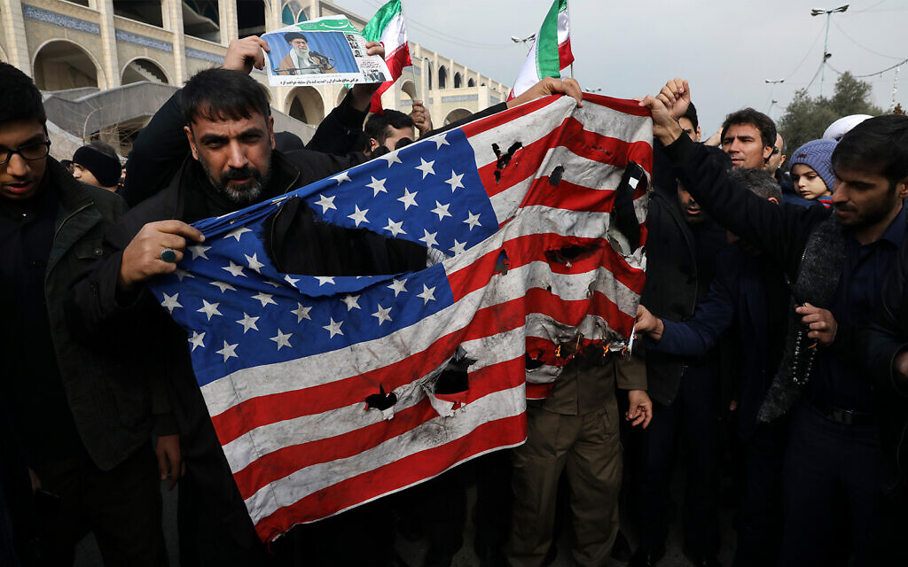 Protesters burn a US flag during a demonstration against the killing of Iranian general Qassem Soleimani in Tehran, Iran, January 3, 2020. (AP Photo/Vahid Salemi) Protesters burn a US flag during a demonstration against the killing of Iranian general Qassem Soleimani in Tehran, Iran, January 3, 2020. (AP Photo/Vahid Salemi)