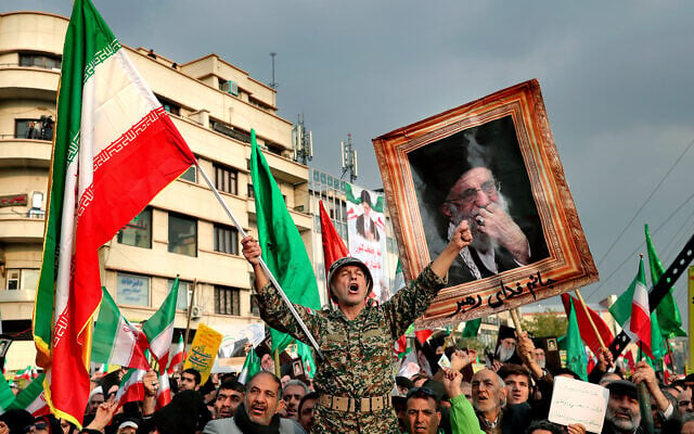 llustrative: demonstrators chant slogans while holding up an Iranian national flag during a pro-government rally in Tehran, Iran, November 25, 2019. (AP/Ebrahim Noroozi, File) llustrative: demonstrators chant slogans while holding up an Iranian national flag during a pro-government rally in Tehran, Iran, November 25, 2019. (AP/Ebrahim Noroozi, File)