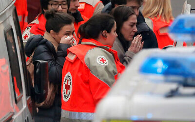 People are evacuated from the French satirical newspaper Charlie Hebdo's office, in Paris, January 7, 2015. (AP Photo/Francois Mori)