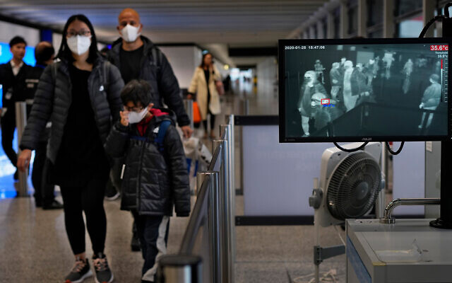 Health surveillance officers use a temperature scanner to monitor passengers arriving at Hong Kong International Airport in Hong Kong, Jan. 25, 2020. (AP/Vincent Yu) Health surveillance officers use a temperature scanner to monitor passengers arriving at Hong Kong International Airport in Hong Kong, Jan. 25, 2020. (AP/Vincent Yu)