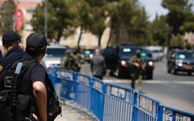 Illustrative. A police officer stands guard at a road block in Jerusalem in an undated photograph. (Israel Police)