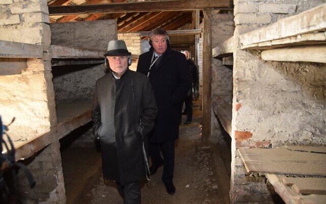 Members of the EJA delegation walk through the barracks in Birkenau known as the 'death barracks,' where women were sent when they were close to death, January 21, 2020. (Yoni Rykner/ EJA)