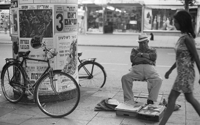 Selling newspapers on Dizengoff Boulevard, from 'Emerging from the Shadows' exhibit at Beit Avi Chai, through June 2020 (Courtesy Sarah Ayal) Selling newspapers on Dizengoff Boulevard, from 'Emerging from the Shadows' exhibit at Beit Avi Chai, through June 2020 (Courtesy Sarah Ayal)