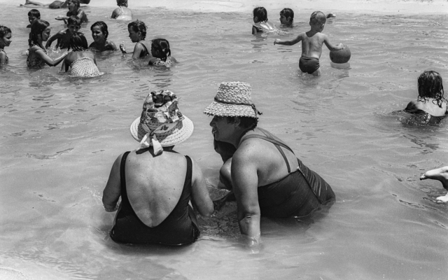 Sitting and chatting in the sea, from 'Emerging from the Shadows' exhibit at Beit Avi Chai, through June 2020 (Courtesy Sarah Ayal) Sitting and chatting in the sea, from 'Emerging from the Shadows' exhibit at Beit Avi Chai, through June 2020 (Courtesy Sarah Ayal)