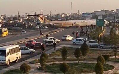 Scene after an Iranian passenger airliner carrying some 150 passengers skidded off the runway and into a street next to the airport in the southern city of Mahshahr, January 27, 2020 (Screen capture: Twitter)