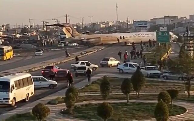 Scene after an Iranian passenger airliner carrying some 150 passengers skidded off the runway and into a street next to the airport in the southern city of Mahshahr, January 27, 2020 (Screen capture: Twitter)
