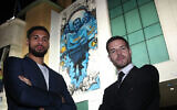 Chelsea soccer players Cesar Azpilicueta, right, and Ruben Loftus-Cheek stand against the club's mural commemorating Holocaust victims in London, Jan. 15, 2020.(Courtesy of Chelsea FC via JTA)