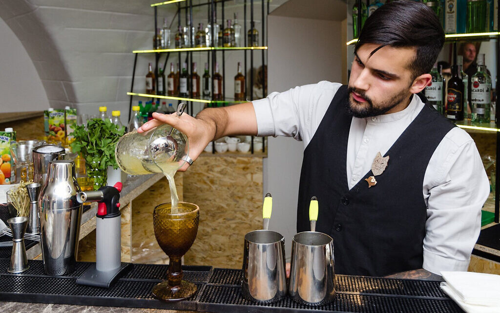 A bartender prepares a cocktail at Kosher Bar in Odessa, Ukraine, Sept. 25, 2019. (Courtesy of Kosher Bar via JTA) A bartender prepares a cocktail at Kosher Bar in Odessa, Ukraine, Sept. 25, 2019. (Courtesy of Kosher Bar via JTA)