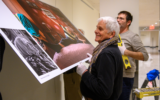 Veteran photojournalist Jim Hollander hanging photographs for The Lonka Project exhibition in the UN, which opened January 27, 2020. (Courtesy Enrique Shore/The Lonka Project)