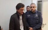 Michael Nikolkin appears at Tel Aviv District Court, accused of stabbing to death his half-brother Evgeny Kleinman, January 2, 2020 (Screen grab via Channel 12)