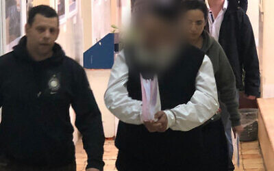The alleged leader of a cult of dozens of women and young children is brought to a court in Jerusalem, January 13, 2020 (Channel 12 news)