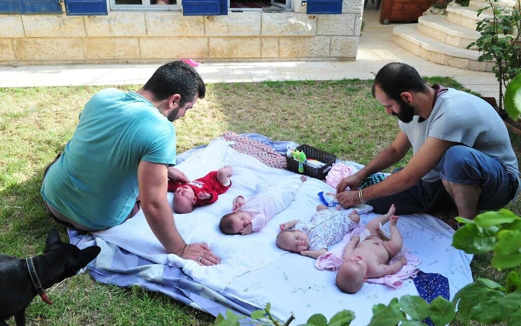 Gil Yehoshua (right) and his spouse, Michael, with their four children (Rafi Koch)