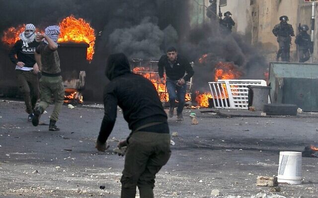 Palestinians clash with Israeli security forces during the funeral of Palestinian policeman Tareq Badwa, in the northern West Bank village of Azzun, on February 7, 2020. (Jaafar Ashtiyeh/AFP) Palestinians clash with Israeli security forces during the funeral of Palestinian policeman Tareq Badwa, in the northern West Bank village of Azzun, on February 7, 2020. (Jaafar Ashtiyeh/AFP)