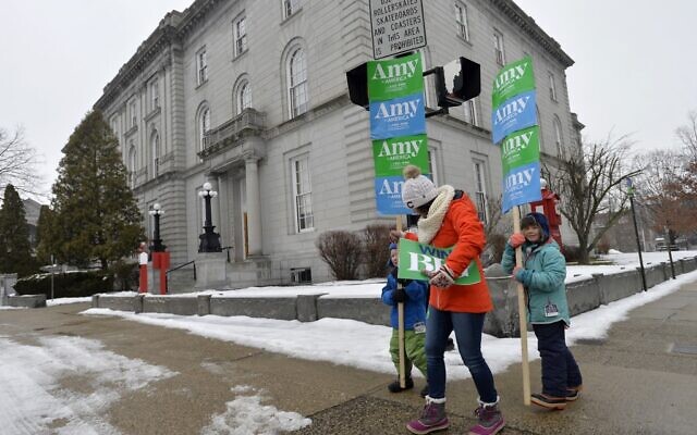 Supporters of Democratic presidential candidate Sen. Amy Klobuchar of Minnesota walk by the State House during the New Hampshire primary in Concord, New Hampshire on February 11, 2020. (Joseph Prezioso/AFP) Supporters of Democratic presidential candidate Sen. Amy Klobuchar of Minnesota walk by the State House during the New Hampshire primary in Concord, New Hampshire on February 11, 2020. (Joseph Prezioso/AFP)