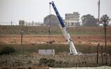 A picture taken in Rafah in the southern Gaza Strip at the border with Egypt shows a crane at the construction site of a wall on the Egyptian side of the border on February 19, 2020. (Said Khatib/AFP)