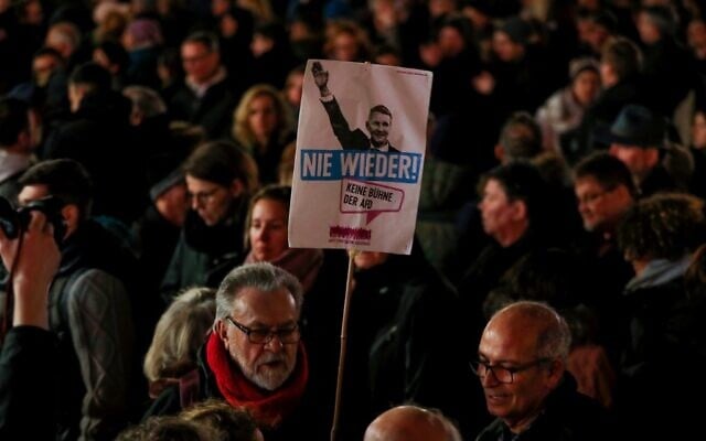 A man holds a placard featuring Regional leader of AfD Thuringia Bjoern Hoecke and the words 'Never again' during a vigil in Hanau, near Frankfurt am Main, western Germany, on February 20, 2020, after at least nine people were killed in two shootings late on February 19, 2020 (Odd ANDERSEN / AFP) A man holds a placard featuring Regional leader of AfD Thuringia Bjoern Hoecke and the words 'Never again' during a vigil in Hanau, near Frankfurt am Main, western Germany, on February 20, 2020, after at least nine people were killed in two shootings late on February 19, 2020 (Odd ANDERSEN / AFP)