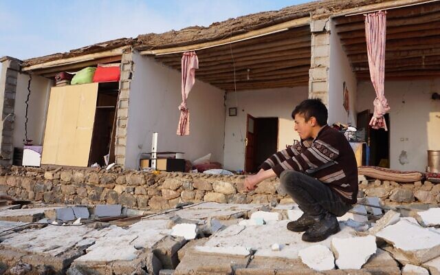 A Turkish child kneels by a destroyed house in Baskale, in the Van province, after a magnitude 5.7 earthquake in northwestern Iran killed at least nine people in neighboring Turkey and injured dozens more on both sides of the border, authorities said, on February 23, 2020. (Demiroren News Agency (DHA)/AFP) A Turkish child kneels by a destroyed house in Baskale, in the Van province, after a magnitude 5.7 earthquake in northwestern Iran killed at least nine people in neighboring Turkey and injured dozens more on both sides of the border, authorities said, on February 23, 2020. (Demiroren News Agency (DHA)/AFP)