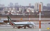 An Alitalia plane is seen parked on the tarmac at Ben Gurion International Airport on February 27, 2020, after passengers traveling from Italy were denied entry to Israel. (Jack Guez/AFP)