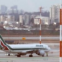 An Alitalia plane is seen parked on the tarmac at Ben Gurion International Airport on February 27, 2020, after passengers traveling from Italy were denied entry to Israel. (Jack Guez/AFP)