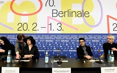 Iranian actress Baran Rasoulof, second left, and actor Kaveh Ahangar, second right, sit next to the empty chair of Iranian director Mohammad Rasoulof, who is unable to leave his home country, during a press conference for the film 'Sheytan Vojud Nadarad' (There is no Evil) screened in competition at the 70th Berlinale film festival in Berlin on February 28, 2020. (Tobias SCHWARZ / AFP)