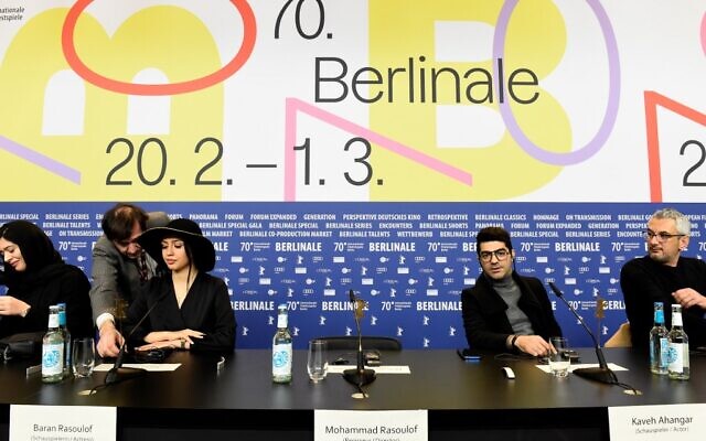 Iranian actress Baran Rasoulof, second left, and actor Kaveh Ahangar, second right, sit next to the empty chair of Iranian director Mohammad Rasoulof, who is unable to leave his home country, during a press conference for the film 'Sheytan Vojud Nadarad' (There is no Evil) screened in competition at the 70th Berlinale film festival in Berlin on February 28, 2020. (Tobias SCHWARZ / AFP) Iranian actress Baran Rasoulof, second left, and actor Kaveh Ahangar, second right, sit next to the empty chair of Iranian director Mohammad Rasoulof, who is unable to leave his home country, during a press conference for the film 'Sheytan Vojud Nadarad' (There is no Evil) screened in competition at the 70th Berlinale film festival in Berlin on February 28, 2020. (Tobias SCHWARZ / AFP)