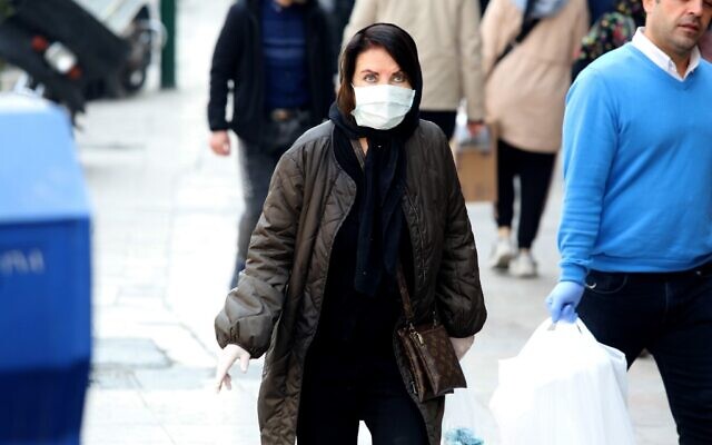 A woman wearing a mask makes her way through Tajrish Bazaar in the Iranian capital Tehran on February 29, 2020. (Atta Kenare/AFP) A woman wearing a mask makes her way through Tajrish Bazaar in the Iranian capital Tehran on February 29, 2020. (Atta Kenare/AFP)