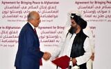 US Special Representative for Afghanistan Reconciliation Zalmay Khalilzad, left, and Taliban co-founder Mullah Abdul Ghani Baradar shake hands after signing a peace agreement during a ceremony in the Qatari capital Doha on February 29, 2020. (Giuseppe Cacace/AFP)