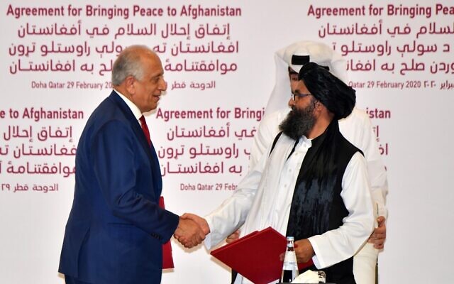 US Special Representative for Afghanistan Reconciliation Zalmay Khalilzad, left, and Taliban co-founder Mullah Abdul Ghani Baradar shake hands after signing a peace agreement during a ceremony in the Qatari capital Doha on February 29, 2020. (Giuseppe Cacace/AFP) US Special Representative for Afghanistan Reconciliation Zalmay Khalilzad, left, and Taliban co-founder Mullah Abdul Ghani Baradar shake hands after signing a peace agreement during a ceremony in the Qatari capital Doha on February 29, 2020. (Giuseppe Cacace/AFP)